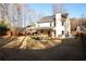Large backyard with a privacy fence, mature trees, and a covered patio area for outdoor enjoyment at 793 Round Tree Ct, Lawrenceville, GA 30045