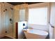 Modern bathroom featuring a glass-enclosed shower, a luxurious soaking tub, and chic fixtures at 793 Round Tree Ct, Lawrenceville, GA 30045