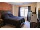 Bedroom featuring a brick accent wall, dark wood furniture, and a comfortable bed at 793 Round Tree Ct, Lawrenceville, GA 30045