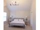 Charming bedroom featuring a vaulted ceiling, a modern chandelier, and coordinated bedside tables at 793 Round Tree Ct, Lawrenceville, GA 30045