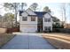 Charming two-story home featuring a two-car garage, white siding, and contrasting shutters at 793 Round Tree Ct, Lawrenceville, GA 30045