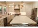 Bright kitchen boasts stainless steel appliances, a large island, pendant lighting, and ample counter space at 793 Round Tree Ct, Lawrenceville, GA 30045