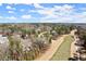 An aerial view of a neighborhood, showcasing the house next to the golf course and green surroundings at 4100 Thunderbird Dr, Marietta, GA 30067