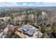 Stunning aerial view of a modern home with a private pool, surrounded by lush greenery and a golf course at 4100 Thunderbird Dr, Marietta, GA 30067