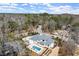 Breathtaking aerial view of a luxurious home with a private pool and patio, nestled among mature trees at 4100 Thunderbird Dr, Marietta, GA 30067