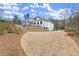 Backyard view of the house, showcasing the large lot, multi-tiered hardscape, and stairs at 4100 Thunderbird Dr, Marietta, GA 30067