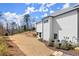 View of the backyard featuring a grassy area and the house with a white brick exterior at 4100 Thunderbird Dr, Marietta, GA 30067