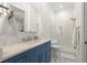 Bathroom with white countertop, blue vanity, and glass enclosed shower at 4100 Thunderbird Dr, Marietta, GA 30067