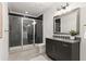 Stylish bathroom featuring a glass-enclosed shower, dark cabinets, quartz countertop, and modern fixtures at 4100 Thunderbird Dr, Marietta, GA 30067