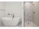 Luxurious bathroom features a soaking tub, glass shower, and elegant fixtures, creating a serene retreat at 4100 Thunderbird Dr, Marietta, GA 30067