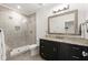 Bright bathroom with glass-enclosed shower, stylish vanity, granite countertop, and a large framed mirror at 4100 Thunderbird Dr, Marietta, GA 30067