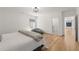 Bright bedroom features hardwood floors, a bed, window, and an ensuite bathroom at 4100 Thunderbird Dr, Marietta, GA 30067