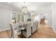 Elegant dining room with chandelier lighting, hardwood floors, and a large table perfect for gatherings at 4100 Thunderbird Dr, Marietta, GA 30067