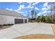 Long driveway leading to a two-car garage, with ample parking space and a basketball hoop in the backyard at 4100 Thunderbird Dr, Marietta, GA 30067