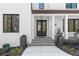 Inviting entryway with double doors, stone steps, and elegant planters enhancing curb appeal at 4100 Thunderbird Dr, Marietta, GA 30067