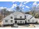 Elegant two-story home with a classic design and a welcoming front porch, enhanced by beautiful landscaping at 4100 Thunderbird Dr, Marietta, GA 30067