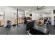 Home gym featuring workout equipment, mirrored wall, and adjoining rec room with pool table and seating at 4100 Thunderbird Dr, Marietta, GA 30067