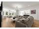 Spacious living room with large sectional, wood floors, modern chandelier, and lots of natural light at 4100 Thunderbird Dr, Marietta, GA 30067