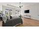 Spacious main bedroom featuring hardwood floors, ceiling fan and backyard view at 4100 Thunderbird Dr, Marietta, GA 30067