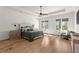Spacious main bedroom featuring hardwood floors, tray ceiling, and plenty of natural light at 4100 Thunderbird Dr, Marietta, GA 30067