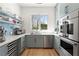 Spacious pantry features custom shelves, stainless appliances, and a window for natural light at 4100 Thunderbird Dr, Marietta, GA 30067