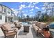 Spacious patio featuring comfortable outdoor furniture, a fire pit, and clear view of the sparkling pool behind the home at 4100 Thunderbird Dr, Marietta, GA 30067