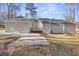 Spacious backyard with a concrete patio, a deck, and plenty of green space surrounded by mature trees at 6010 Canaan Woods Dr, South Fulton, GA 30331