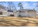 Spacious backyard with a green lawn and mature trees features a deck and neutral colored siding at 6010 Canaan Woods Dr, South Fulton, GA 30331