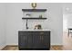 Stylish bar area with dark cabinetry, floating shelves, and modern fixtures at 6010 Canaan Woods Dr, South Fulton, GA 30331