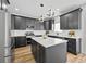 Bright kitchen featuring dark cabinetry, a central island, stainless steel appliances, and modern pendant lighting at 6010 Canaan Woods Dr, South Fulton, GA 30331