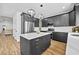 Contemporary kitchen featuring dark cabinets, a central island, and stainless steel appliances at 6010 Canaan Woods Dr, South Fulton, GA 30331