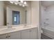 Bright bathroom with a double sink vanity, large mirror, and a shower-tub combo at 793 River Gardens Dr, Atlanta, GA 30354