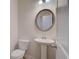 Bathroom features a pedestal sink and a round mirror at 793 River Gardens Dr, Atlanta, GA 30354