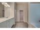 Well lit bathroom with double sink vanity, wood-style tile flooring and glass shower at 793 River Gardens Dr, Atlanta, GA 30354