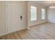 Elegant entryway featuring light wood flooring, white trim and modern lighting at 793 River Gardens Dr, Atlanta, GA 30354