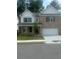 Charming two-story home with a brick facade, a two-car garage, and a well-manicured front lawn at 793 River Gardens Dr, Atlanta, GA 30354