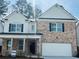 Charming two-story home with a brick facade, white accents and a two car garage at 793 River Gardens Dr, Atlanta, GA 30354