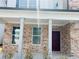 Inviting brick front porch with white columns, leading to a dark wood front door at 793 River Gardens Dr, Atlanta, GA 30354