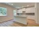 Bright kitchen features stainless appliances, granite countertops, white cabinets, and an island with barstool seating at 793 River Gardens Dr, Atlanta, GA 30354