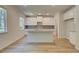 Bright kitchen features stainless appliances, granite countertops, white cabinets, and an island with barstool seating at 793 River Gardens Dr, Atlanta, GA 30354