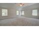 Large main bedroom with neutral carpet, ceiling fan, and multiple windows at 793 River Gardens Dr, Atlanta, GA 30354