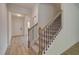 Hallway view of staircase with carpeted steps and wrought iron railing at 793 River Gardens Dr, Atlanta, GA 30354