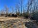 A spacious backyard featuring a stone paver area and mature trees at 8008 Revere Dr, Mcdonough, GA 30252