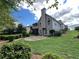 Expansive backyard featuring a stone patio, lush green lawn, and a charming two-story home exterior at 8008 Revere Dr, Mcdonough, GA 30252