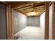 Unfinished basement with concrete walls, exposed ceiling with a single light at 8008 Revere Dr, Mcdonough, GA 30252