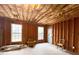 Unfinished basement space with exposed framing, insulation, and natural light from windows at 8008 Revere Dr, Mcdonough, GA 30252