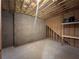 Unfinished basement with concrete walls, exposed ceiling and basic shelving at 8008 Revere Dr, Mcdonough, GA 30252