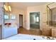 Bathroom with dual sinks, soaking tub, and shower, leading into a spacious Primary bedroom at 8008 Revere Dr, Mcdonough, GA 30252