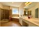 Bathroom featuring double sinks, a soaking tub, and a glass enclosed shower at 8008 Revere Dr, Mcdonough, GA 30252