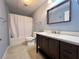 Well-lit bathroom featuring a wooden vanity with solid surface countertops and a shower with curtain at 8008 Revere Dr, Mcdonough, GA 30252